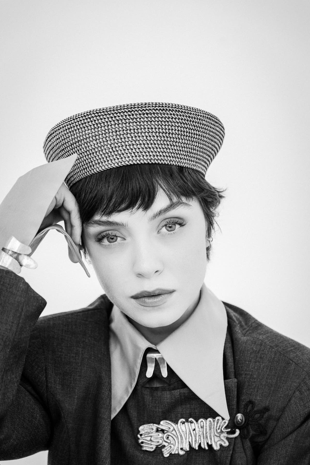 Beauty portrait in a houndstooth cap and tailored jacket, black and white